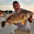 files/Angler_Holding_Trophy_Freshwater_Drum_at_Dockside.png